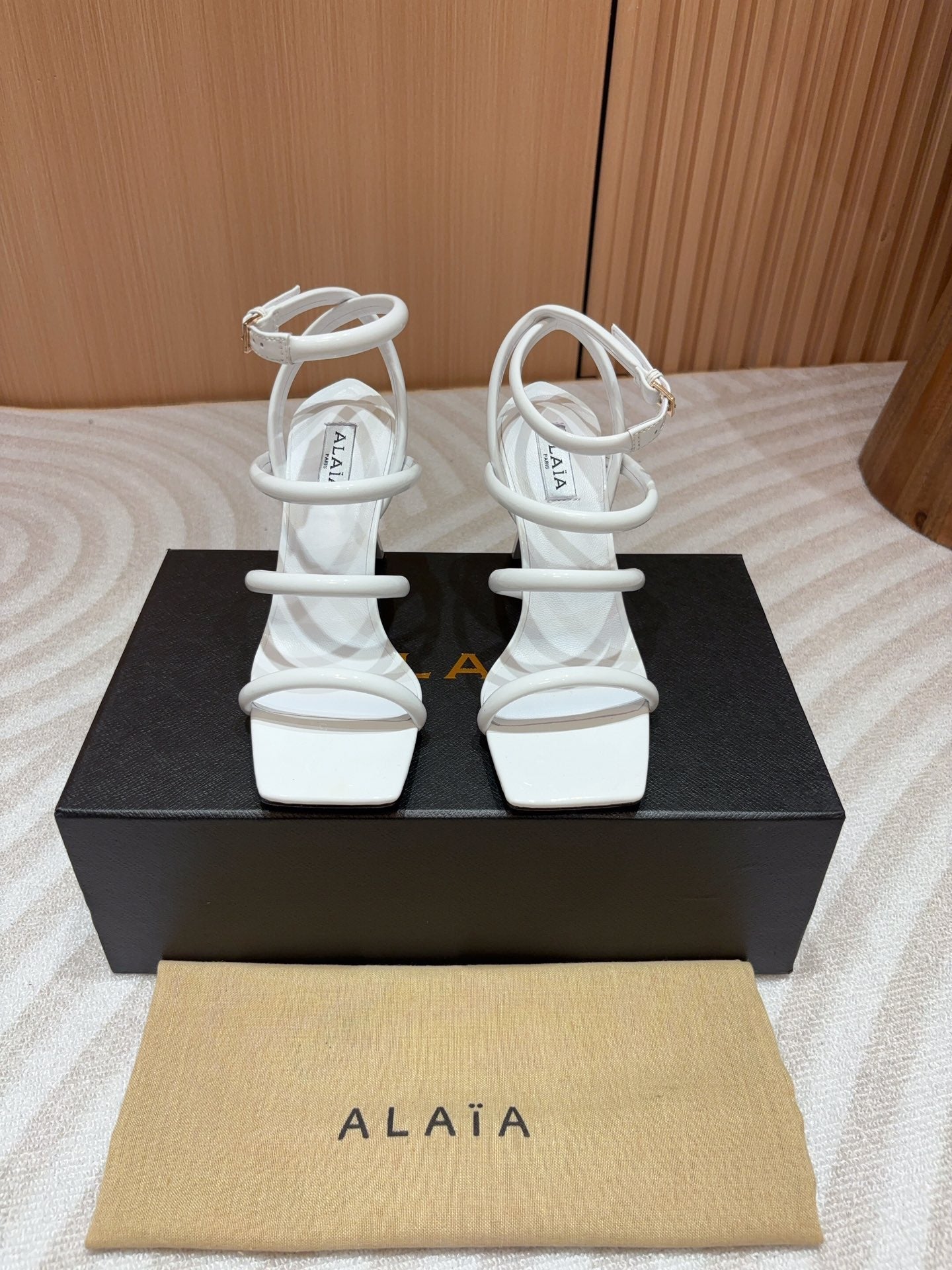 ALAIA THREE-STRAPS HIGH HEEL SANDALS IN WHITE PATENT LAMBSKIN