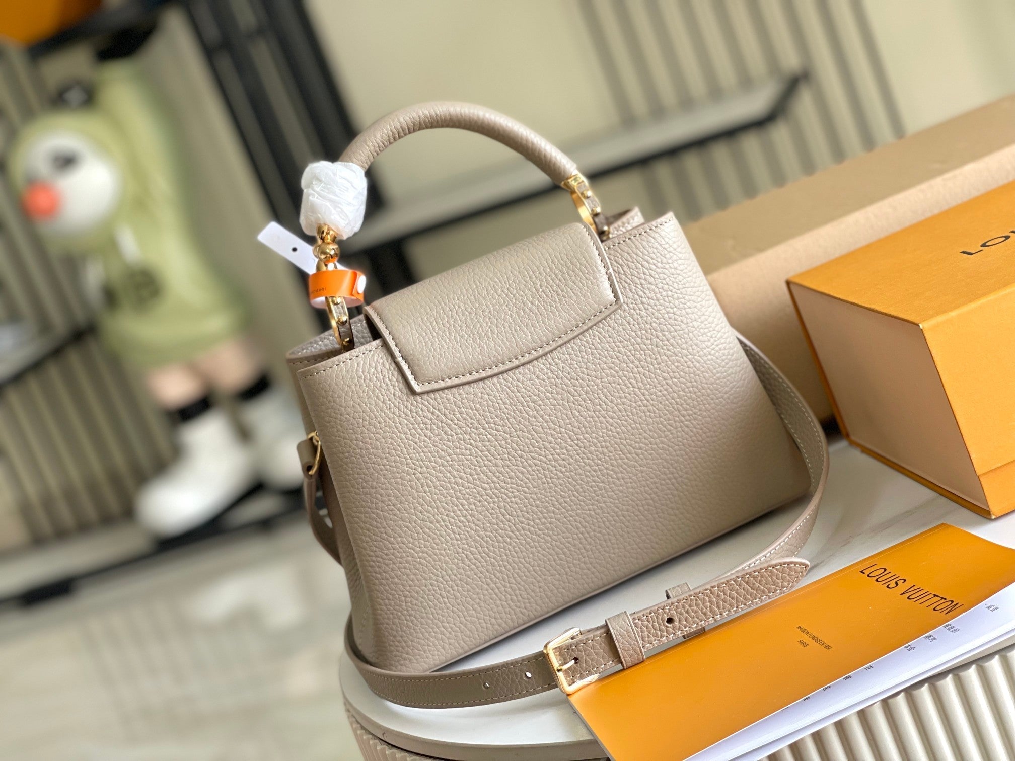 CAPUCINES BB 27 DARK BEIGE TAURILLON GOLD HARDWARE